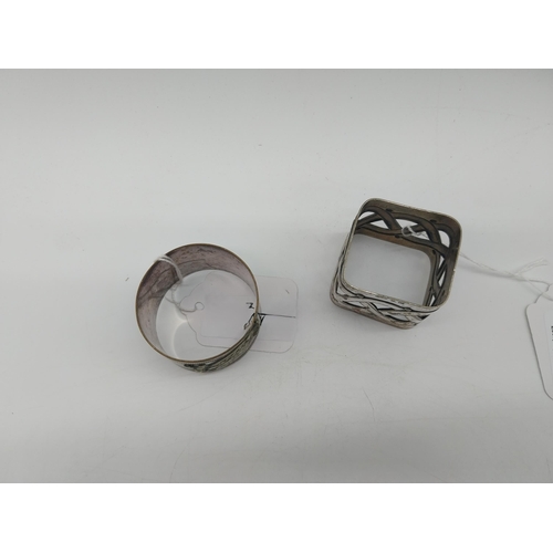 1010 - Two silver plated napkin rings . Square holder stamped WMFN x/o OX. Circular holder decorated with a... 