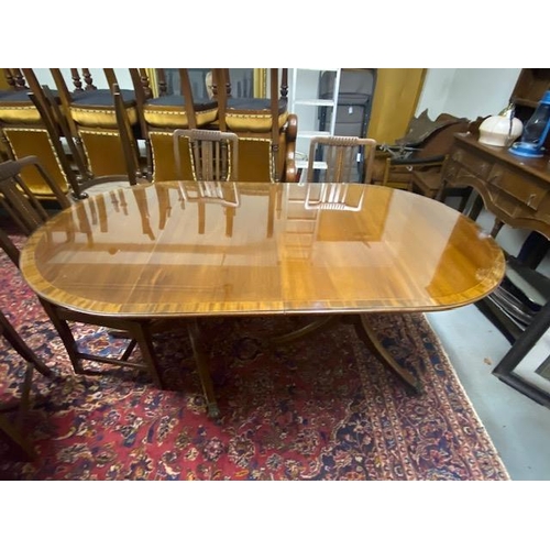 1112 - Inlaid mahogany dining room table, raised on double turned pod each with three outswept feet. { 74cm... 