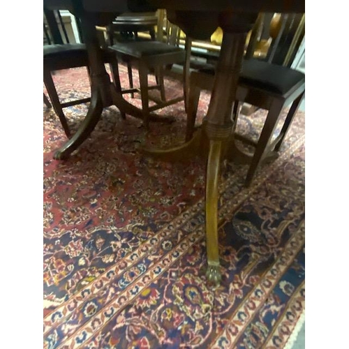 1112 - Inlaid mahogany dining room table, raised on double turned pod each with three outswept feet. { 74cm... 