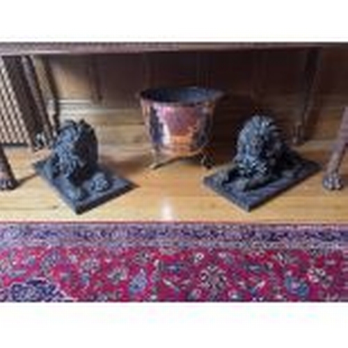 68 - Pair of recumbent bronze lions, mounted on marble bases.