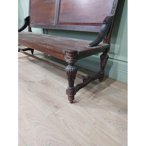 460a - Carved hardwood hall bench the back with two raised inset panels, raised on turned tapered legs and ... 