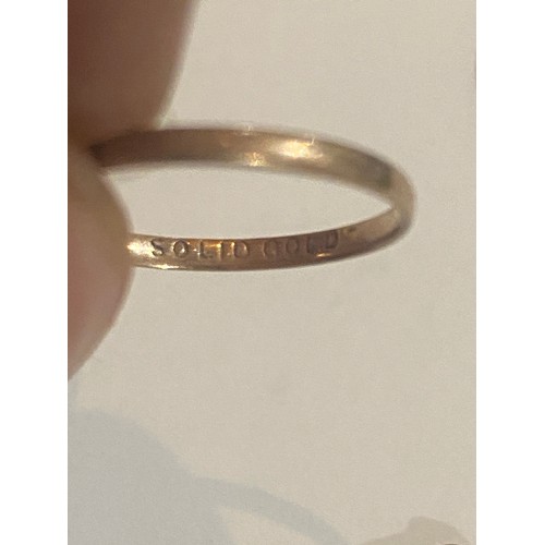 1037 - 14K Gold ring. Size K.  Gold wedding ring, stamped Solid Gold. Size N and a scrap yellow metal ring.