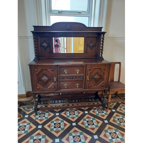 39 - 1950's oak sideboard, the mirrored back above two centre drawers flanked by two panelled doors raise... 