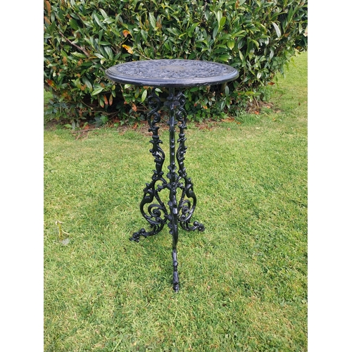 377 - Decorative cast iron garden table on three outswept legs. {70 cm H x 36 cm Dia.}.