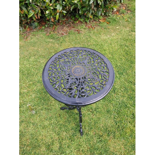 377 - Decorative cast iron garden table on three outswept legs. {70 cm H x 36 cm Dia.}.