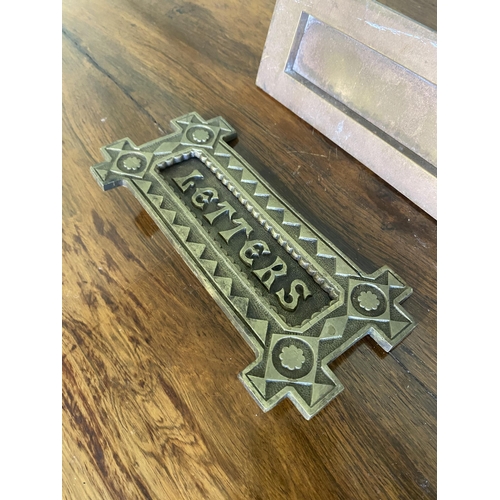 33 - Two early 20th C. brass door letter boxes {8 cm H x 20 cm W x 6 cm D and 9 cm W x 19 cm W}.