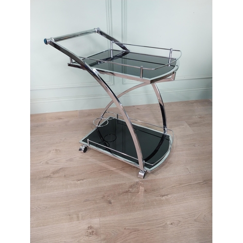 14 - Good quality retro chrome and smoked glass drink's trolley. {74 cm H x 66 cm W x 46 cm D}.