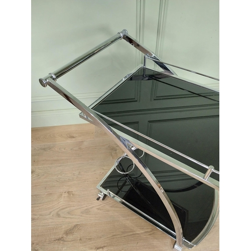 14 - Good quality retro chrome and smoked glass drink's trolley. {74 cm H x 66 cm W x 46 cm D}.
