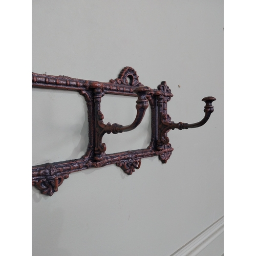 16 - Bronzed painted cast iron hanging coat rack. {19 cm H x 63 cm W x 11 cm D}.
