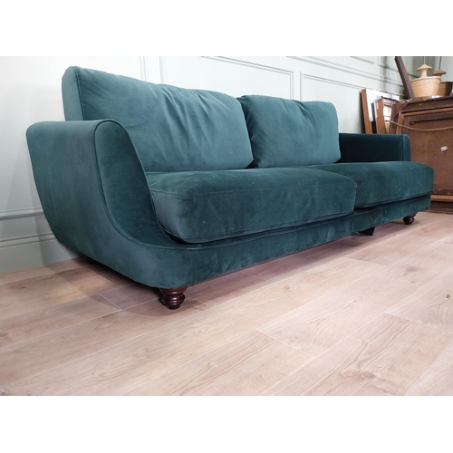18 - Vintage style three seater sofa with green crushed upholstery raised on ebonised legs. {83 cm H x 20... 