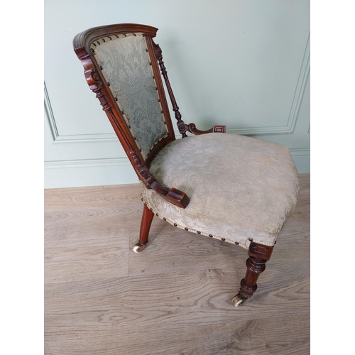 26 - Victorian walnut and upholstered nursing chair on turned legs with brass castors.{70 cm H x 50 cm W ... 