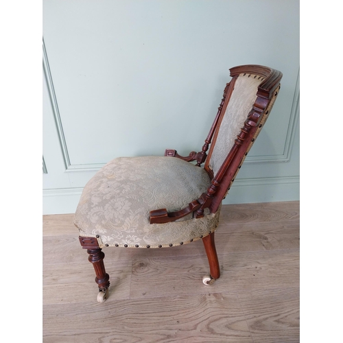 26 - Victorian walnut and upholstered nursing chair on turned legs with brass castors.{70 cm H x 50 cm W ... 