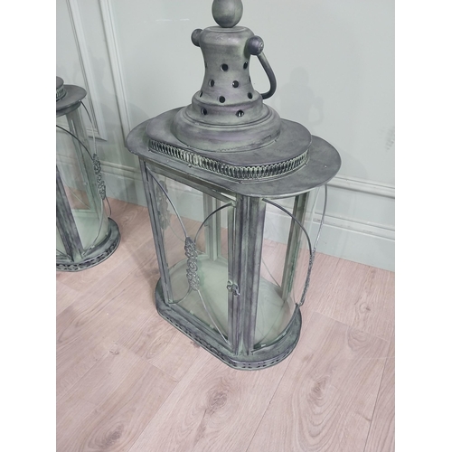 36 - Pair of bronzed metal candle lanterns with glass panels. {75 cm H x 40 cm W x 27 cm D}
