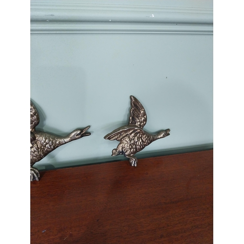 48 - Graduated set of three brass flying Ducks. {25 cm H x 29 cm W to 18 cm H x 12 cm W}