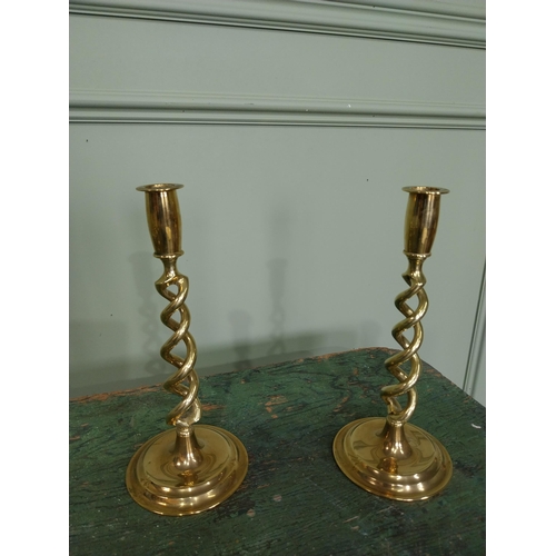 60 - Pair of brass candlesticks with spiral column. {26 cm H x 11 cm Dia.}.