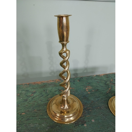 60 - Pair of brass candlesticks with spiral column. {26 cm H x 11 cm Dia.}.