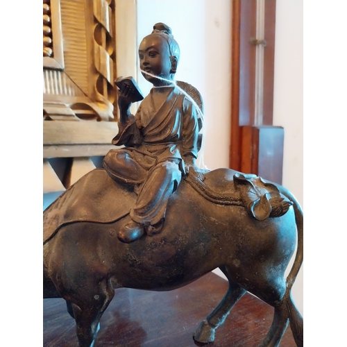 154 - Oriental bronze figure of a Man riding a Water Buffalo. { 53cm H X 25cm W X 9cm D }.