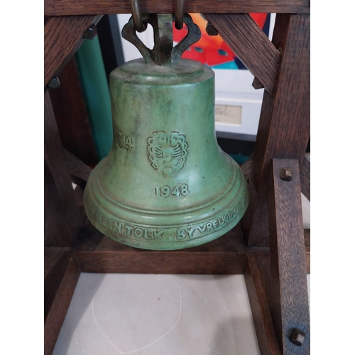 347 - Early 20th. C. bronze table bell, mounted on oak stand. { 23cm H X 43cm W X 24cm D }.