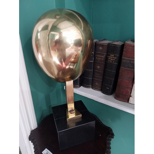 355 - Comtemporary bronze sculpture of a Helmet, mounted on a marble base.  { 47cm H X 22cm Sq. }.