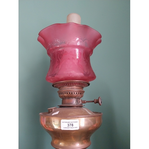 378 - Edwardian brass oil lamp with ruby glass shade. { 60cm H X 22cm Dia }.