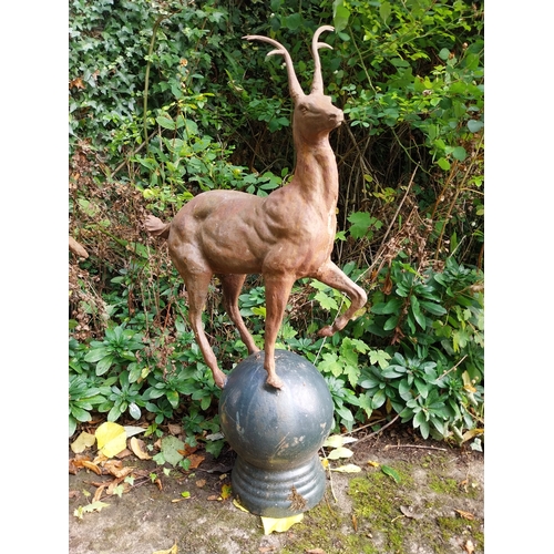 38 - Pair of cast iron models of Stags, mounted on balls. { 90cm H X 57cm W X 25cm D }.