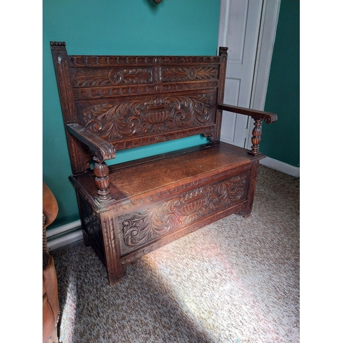 380 - Edwardian carved oak monk's bench with lift up seat.  { 107cm H X 110cm W X 48cm D }.