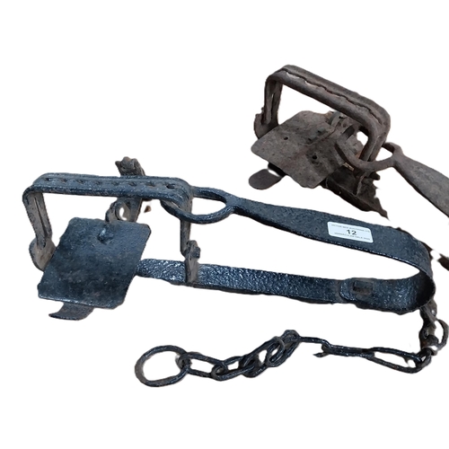 12 - Two 19th C. metal gin traps. {13 cm H x 40 cm W x 19 cm D}.