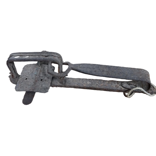 12 - Two 19th C. metal gin traps. {13 cm H x 40 cm W x 19 cm D}.