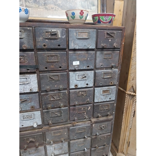 35 - 20th C. oak bank of fifty drawers (two missing). {130 cm H x 90 cm W x 35 cm D}.