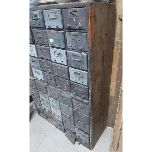 35 - 20th C. oak bank of fifty drawers (two missing). {130 cm H x 90 cm W x 35 cm D}.