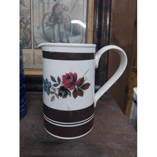 36 - Large blue and white Willow pattern mug and brown jug decorated with flowers. {14 cm H x 17 cm Dia a... 