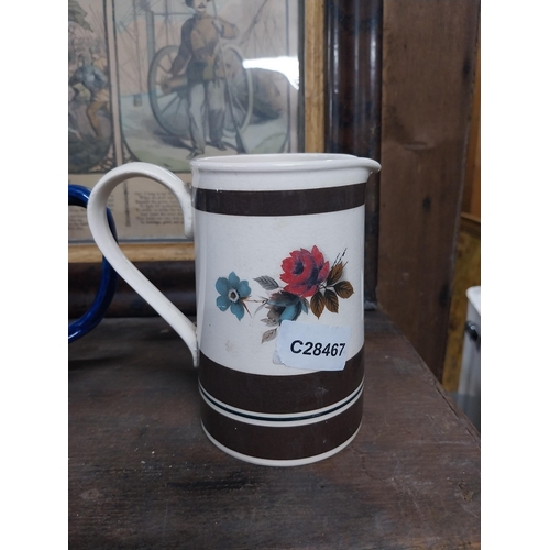 36 - Large blue and white Willow pattern mug and brown jug decorated with flowers. {14 cm H x 17 cm Dia a... 