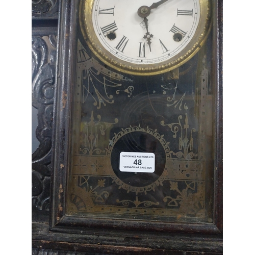 48 - 19th C. carved pine and ebonised ginger bread clock with enamel dial {61 cm H x 41 cm W x 11 cm D}.
