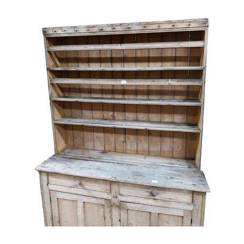 30 - Victorian stripped pine dresser with three shelves over two short drawers and two panelled doors on ... 