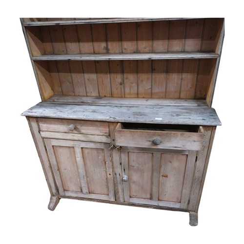 30 - Victorian stripped pine dresser with three shelves over two short drawers and two panelled doors on ... 