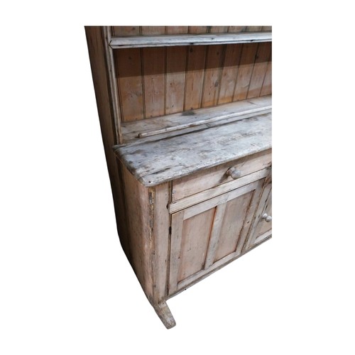 30 - Victorian stripped pine dresser with three shelves over two short drawers and two panelled doors on ... 