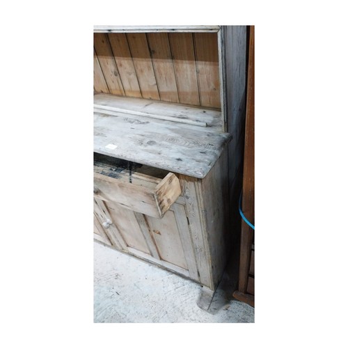 30 - Victorian stripped pine dresser with three shelves over two short drawers and two panelled doors on ... 