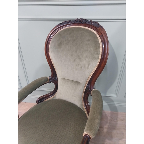 610 - Victorian carved rosewood and upholstered armchair on cabriole legs. {108 cm H x 68 cm W x 64 cm D].