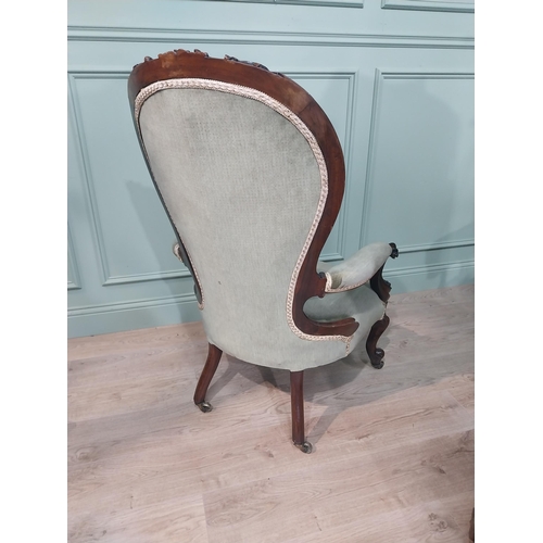 610 - Victorian carved rosewood and upholstered armchair on cabriole legs. {108 cm H x 68 cm W x 64 cm D].