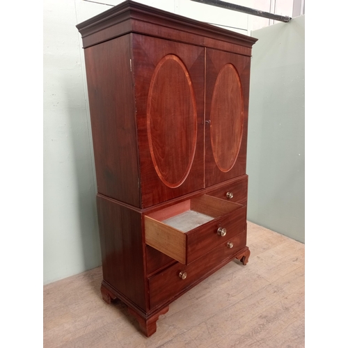 14 - 19th C.  mahogany linen press with two oval panelled doors over two short drawers over two graduated... 