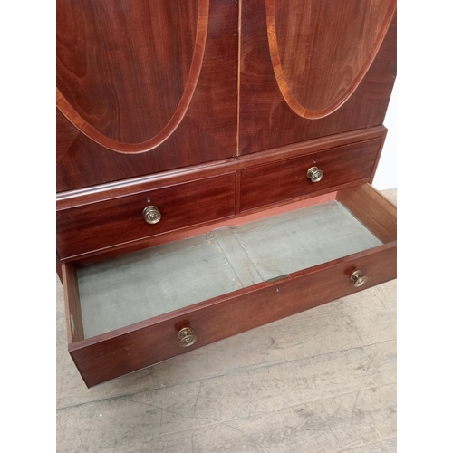 14 - 19th C.  mahogany linen press with two oval panelled doors over two short drawers over two graduated... 