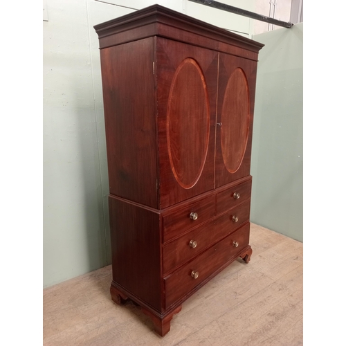 14 - 19th C.  mahogany linen press with two oval panelled doors over two short drawers over two graduated... 
