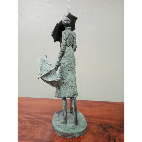 44 - A bronze study of two figures with umbrellas signed on the base. J McCarthy  {H 40cm x W 15cm x D 20... 