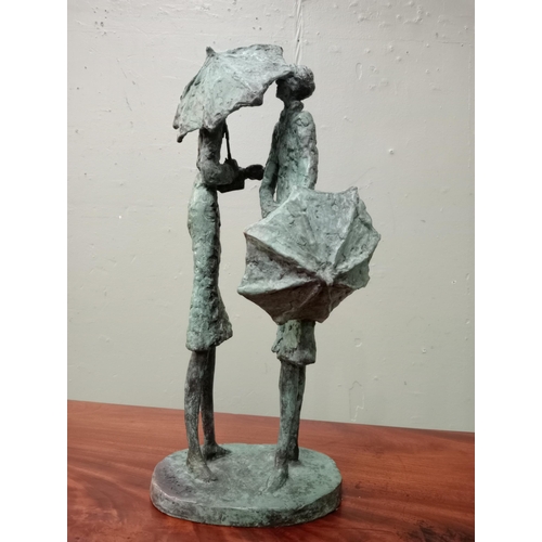 44 - A bronze study of two figures with umbrellas signed on the base. J McCarthy  {H 40cm x W 15cm x D 20... 