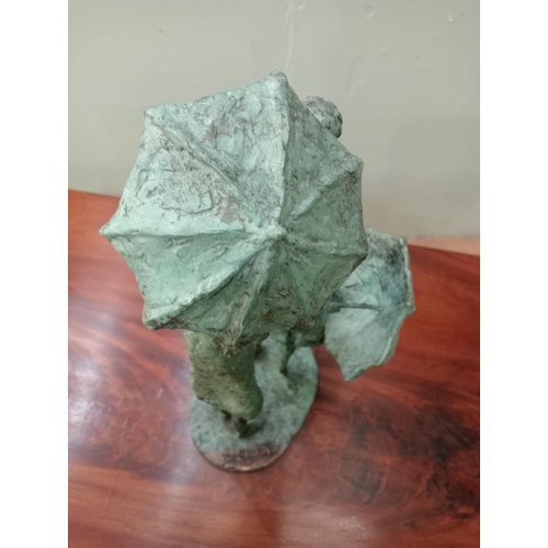 44 - A bronze study of two figures with umbrellas signed on the base. J McCarthy  {H 40cm x W 15cm x D 20... 