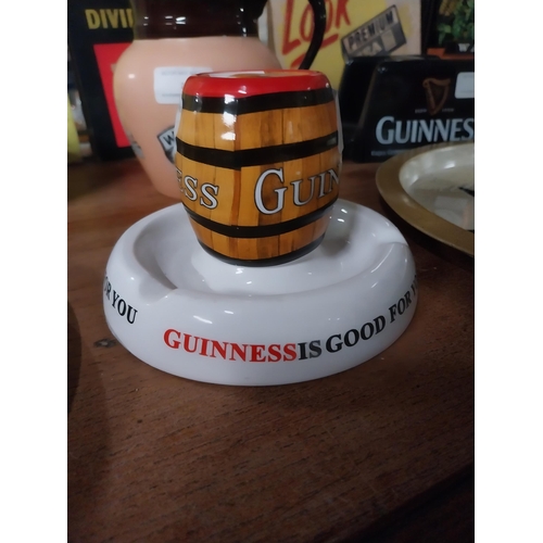 22 - Guinness ceramic matchstrike. {10 cm H x 15 cm Dia.}.