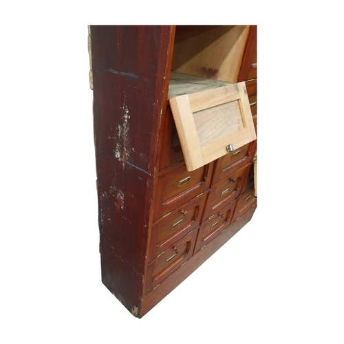40 - Early 20th C. stained pine office cabinet with twenty one drop down doors with brass mounts. {171 cm... 
