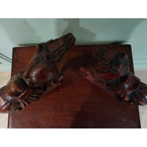 45 - Two carved painted pine models of Oriental Horses. {27 cm H x 28 cm W x 12 cm D}.