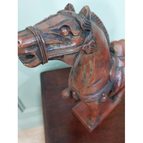 45 - Two carved painted pine models of Oriental Horses. {27 cm H x 28 cm W x 12 cm D}.