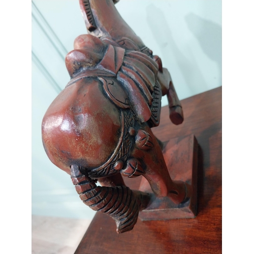 45 - Two carved painted pine models of Oriental Horses. {27 cm H x 28 cm W x 12 cm D}.